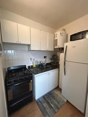 a kitchen with white cabinets and a stove and refrigerator at Richardson in Cordoba