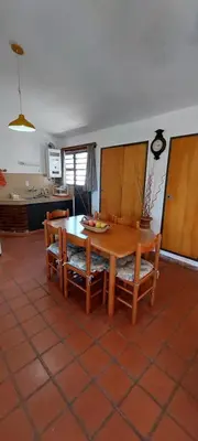 a room with a table and chairs and a kitchen at Ayen Hue Casa Vacacional en Mayu Sumaj in San Antonio de Arredondo