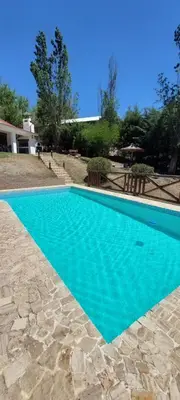 a swimming pool with blue water in a yard at Ayen Hue Casa Vacacional en Mayu Sumaj in San Antonio de Arredondo