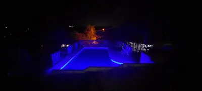 a swimming pool lit up in blue at night at Ayen Hue Casa Vacacional en Mayu Sumaj in San Antonio de Arredondo