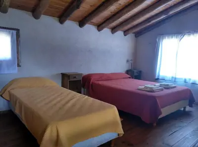 a bedroom with two beds and a window at Cabañas el Ñato in Nono
