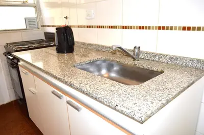a kitchen counter with a sink and a stove at Centro -Patio Olmos-home office - internet rápida- in Cordoba