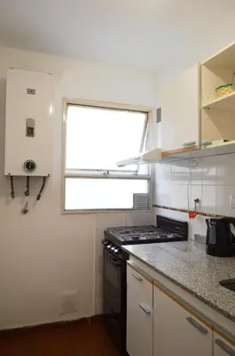 a kitchen with a stove and a window at Centro -Patio Olmos-home office - internet rápida- in Cordoba