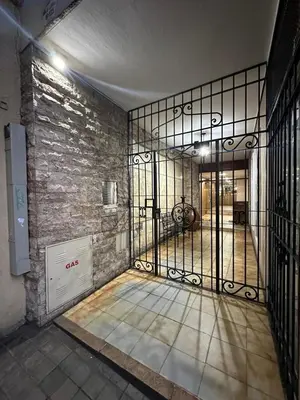 an iron gate in a room with a brick wall at Centro -Patio Olmos-home office - internet rápida- in Cordoba