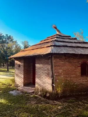 an old brick building with a grass roof at Complejo Las Sierras in Nono