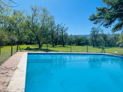a large blue swimming pool in a park at Complejo Las Sierras in Nono