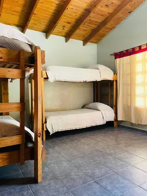 a room with three bunk beds in a house at Complejo Las Sierras in Nono