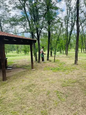 a man standing in a field with a frisbee at Complejo Las Sierras in Nono