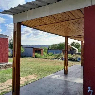 a large wooden pergola on top of a yard at AYRES DE MONTAÑA in San Ignacio