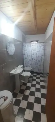 a bathroom with two toilets and a checkered floor at AYRES DE MONTAÑA in San Ignacio