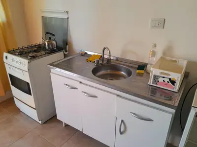 a kitchen with a sink and a stove at AYRES DE MONTAÑA in San Ignacio
