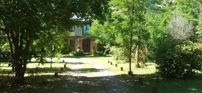 a path in front of a house with trees at Portal del Río Posada in Santa Rosa de Calamuchita