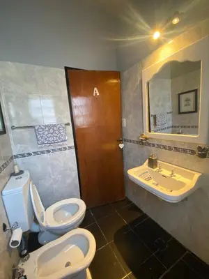 a bathroom with a toilet and a sink at TANTI casa con pileta in Cordoba