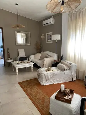 a living room with two beds and a couch at TANTI casa con pileta in Cordoba