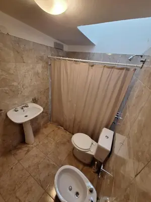 a bathroom with a toilet and a sink at Departamento W R T 2 in Villa Carlos Paz