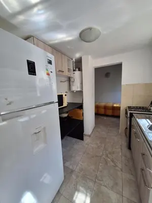 a kitchen with a white refrigerator and a sink at Departamento W R T 2 in Villa Carlos Paz
