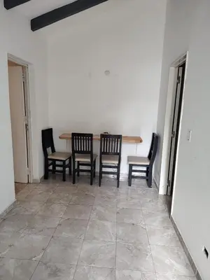 a dining room with a table and four chairs at Departamento W R T 2 in Villa Carlos Paz