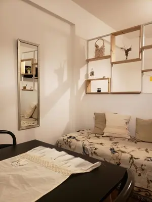 a room with a bed and a mirror and a table at Departamento en Barrio General Paz calle 25 de Mayo in Cordoba