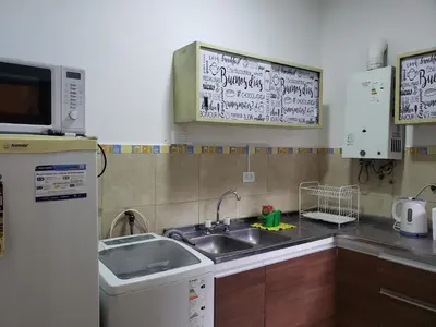 a small kitchen with a sink and a microwave at Departamento en Barrio General Paz calle 25 de Mayo in Cordoba