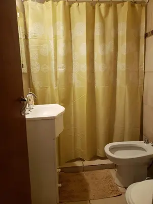 a bathroom with a shower curtain and a toilet at Departamento en Barrio General Paz calle 25 de Mayo in Cordoba