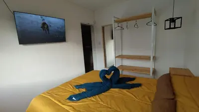 a blue ribbon on a bed in a bedroom at Cabañas Nakupenda in Villa Carlos Paz