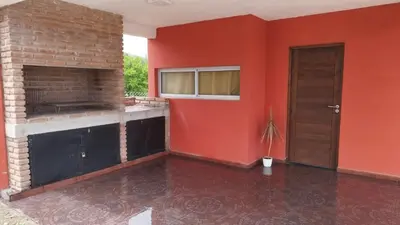 an empty room with a red wall and a door at Cabañas Nakupenda in Villa Carlos Paz