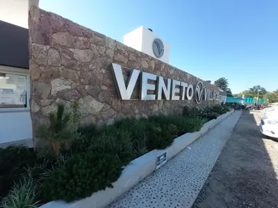 a sign on the side of a building at VENETO VILLAGE MR in Villa Parque Siquiman