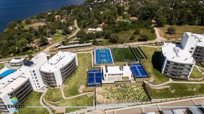 an aerial view of buildings on a hill next to the water at VENETO VILLAGE MR in Villa Parque Siquiman