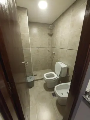 a bathroom with a toilet and a sink at VENETO VILLAGE MR in Villa Parque Siquiman