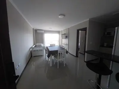 a room with a table and chairs and a kitchen at VENETO VILLAGE MR in Villa Parque Siquiman