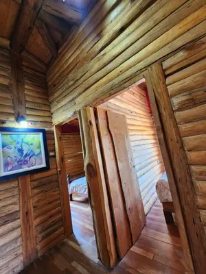 an inside view of a log cabin with a tv at Talasuas -aires de montaña in Villa General Belgrano