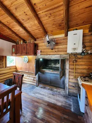a kitchen and living room of a tiny house at Talasuas -aires de montaña in Villa General Belgrano