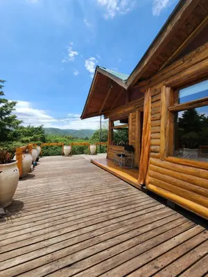 a wooden deck of a house with a view at Talasuas -aires de montaña in Villa General Belgrano