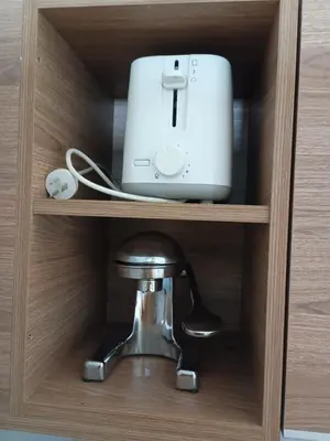 a drawer of a cabinet with a router and a adapter at Depto céntrico excelente ubicación, con cochera, pileta y patio in Villa Carlos Paz
