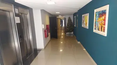 a hallway with a christmas tree in a building at Depto céntrico excelente ubicación, con cochera, pileta y patio in Villa Carlos Paz