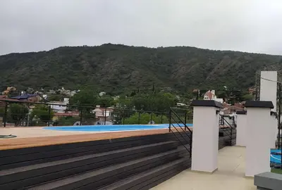 a swimming pool on the roof of a house at Depto céntrico excelente ubicación, con cochera, pileta y patio in Villa Carlos Paz