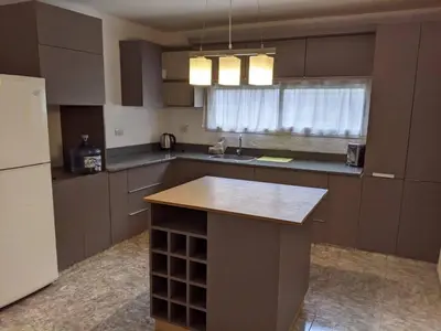 a kitchen with a island in the middle of it at La Calera- Casa vacacional in La Calera