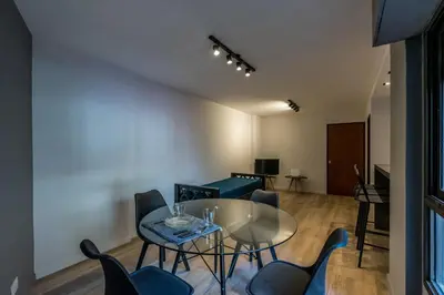 a living room with a glass table and chairs at Hermoso departamento by Lofty in Cordoba