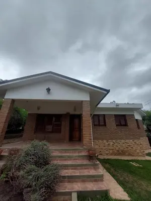 a brick house with stairs in front of it at Casa céntrica en Tanti in Tanti