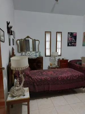 a bedroom with a bed and a lamp on a table at Casa céntrica en Tanti in Tanti