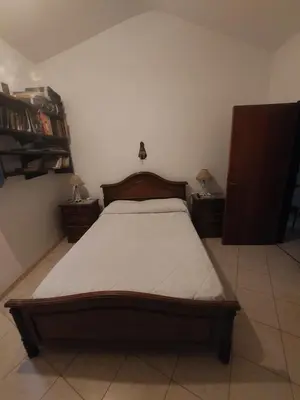 a bedroom with a bed and two night stands at Casa céntrica en Tanti in Tanti