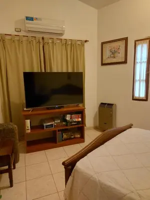 a living room with a flat screen television on a stand at Casa céntrica en Tanti in Tanti