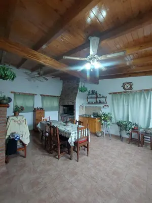 a large living room with a table and chairs at Casa céntrica en Tanti in Tanti
