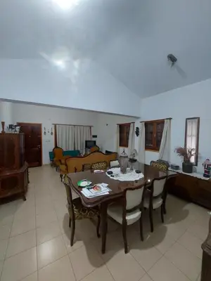 a living room with a wooden table and chairs at Casa céntrica en Tanti in Tanti