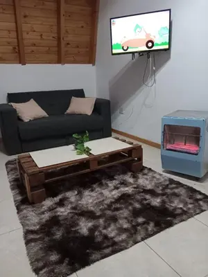 a living room with a couch and a tv at Mi Descanso!!! in Cavalango
