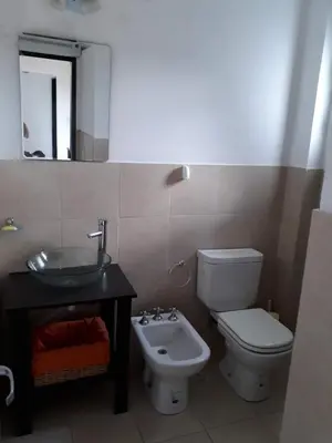 a bathroom with a toilet and a sink and a mirror at Mi Descanso!!! in Cavalango