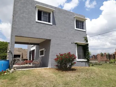 a gray house with two chairs and a yard at Mi Descanso!!! in Cavalango