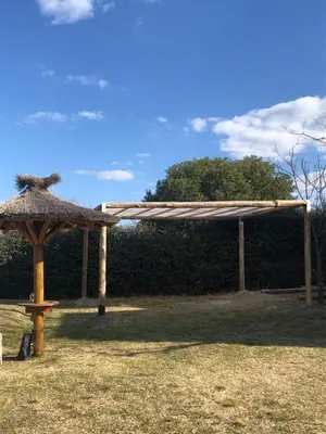a wooden pergola and a bench in a field at Mi Descanso!!! in Cavalango