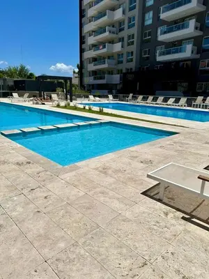 a swimming pool with a table and chairs next to a building at OP Amoblado en Cordoba Capital in Cordoba