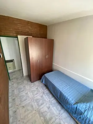 a bedroom with a bed and a cabinet at MIGUEL JUAREZ 47 in Villa Carlos Paz
